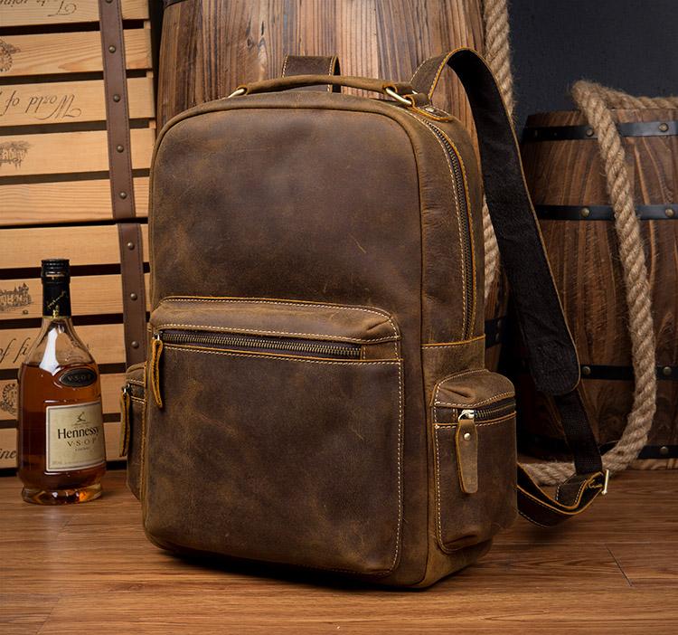 The Langley Backpack made from high-quality crazy horse leather, featuring a rustic deep chocolate brown color and multiple compartments.