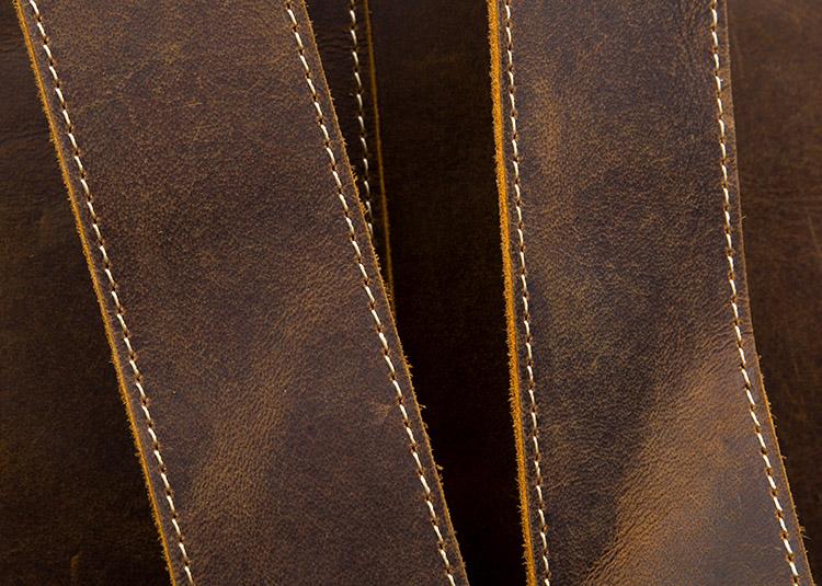 The Langley Backpack made from high-quality crazy horse leather, featuring a rustic deep chocolate brown color and multiple compartments.