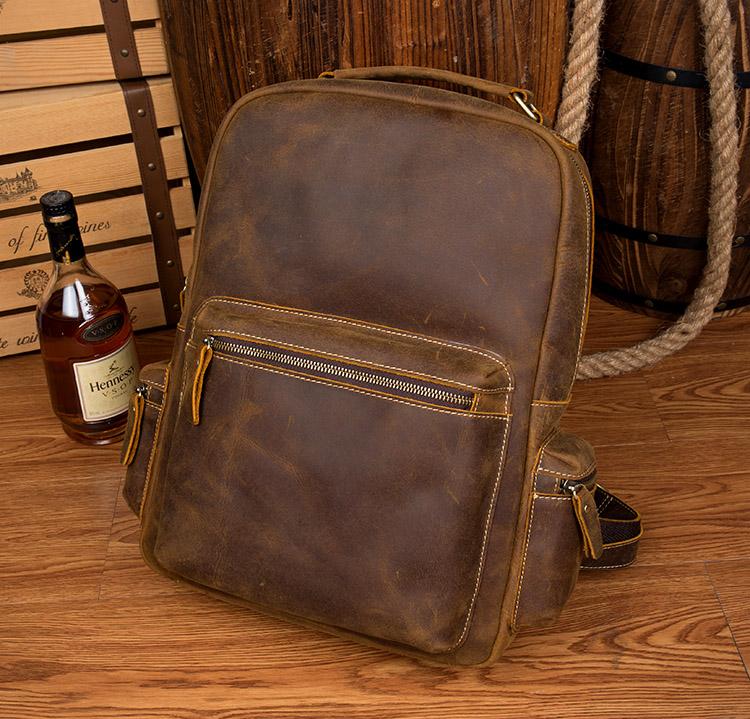 The Langley Backpack made from high-quality crazy horse leather, featuring a rustic deep chocolate brown color and multiple compartments.