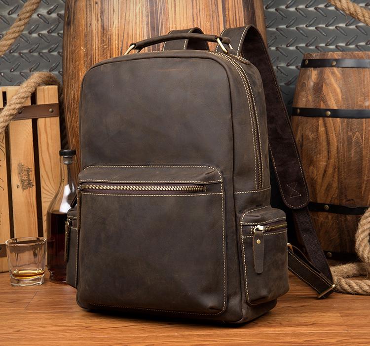 The Langley Backpack made from high-quality crazy horse leather, featuring a rustic deep chocolate brown color and multiple compartments.