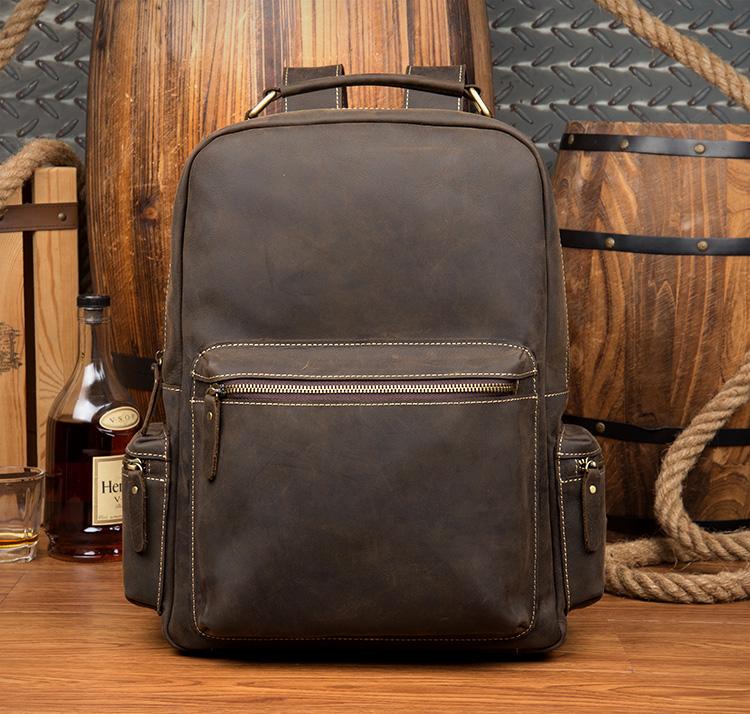 The Langley Backpack made from high-quality crazy horse leather, featuring a rustic deep chocolate brown color and multiple compartments.