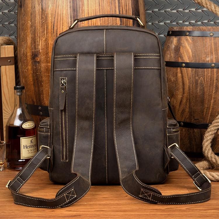 The Langley Backpack made from high-quality crazy horse leather, featuring a rustic deep chocolate brown color and multiple compartments.