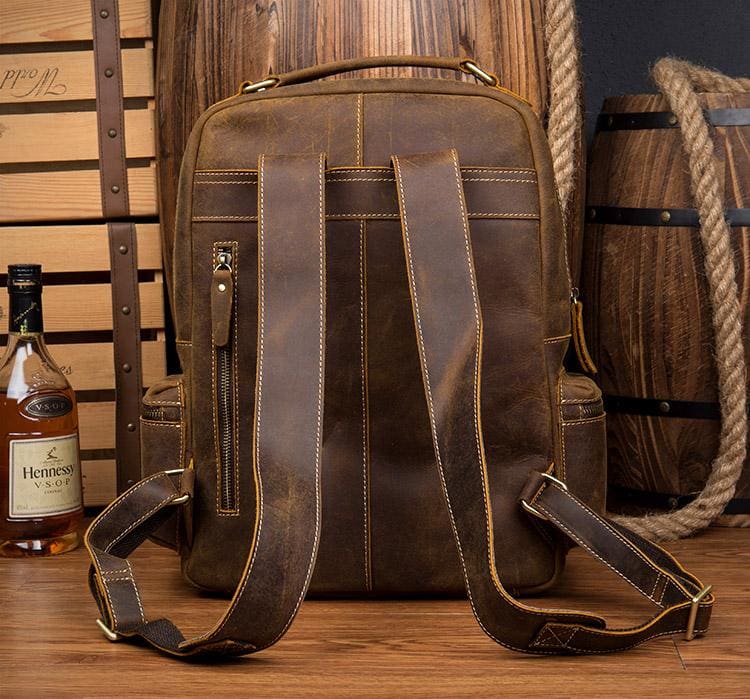 The Langley Backpack made from high-quality crazy horse leather, featuring a rustic deep chocolate brown color and multiple compartments.