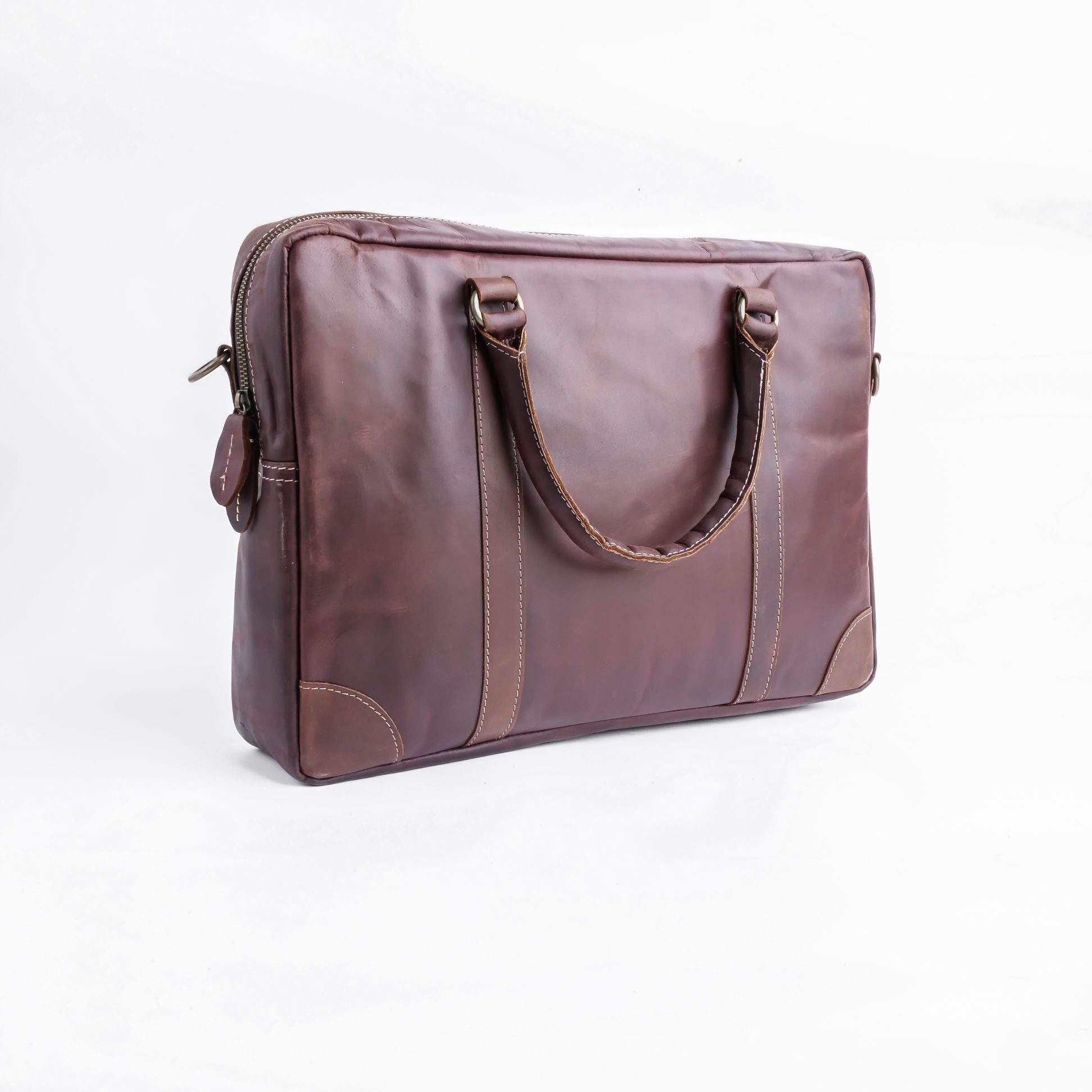 The Maverick Vintage Leather Laptop Bag in Midnight Brown, showcasing its premium leather, adjustable shoulder strap, and spacious design.