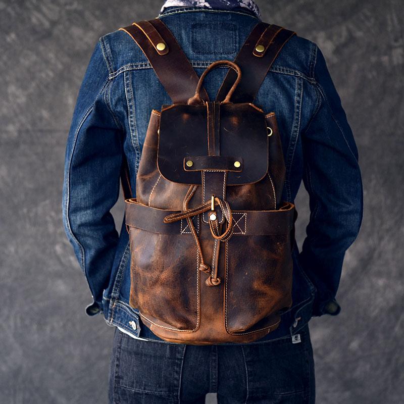 The Olaf Rucksack, a vintage leather travel backpack with two front pockets and adjustable straps, showcasing its unique retro style.