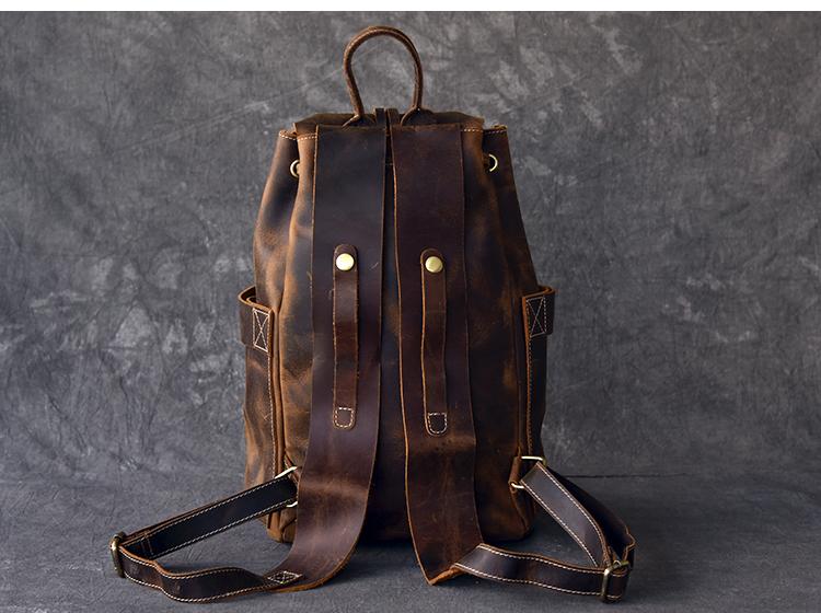 The Olaf Rucksack, a vintage leather travel backpack with two front pockets and adjustable straps, showcasing its unique retro style.