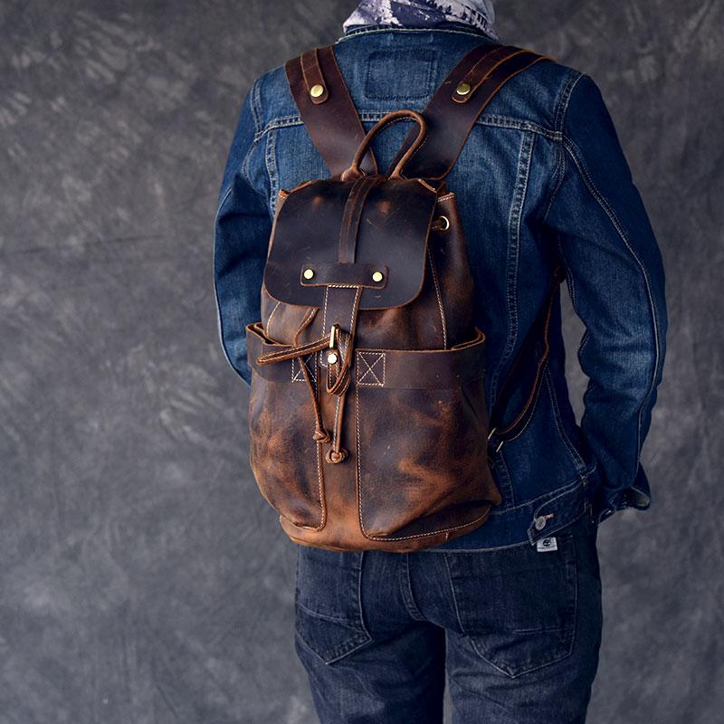 The Olaf Rucksack, a vintage leather travel backpack with two front pockets and adjustable straps, showcasing its unique retro style.