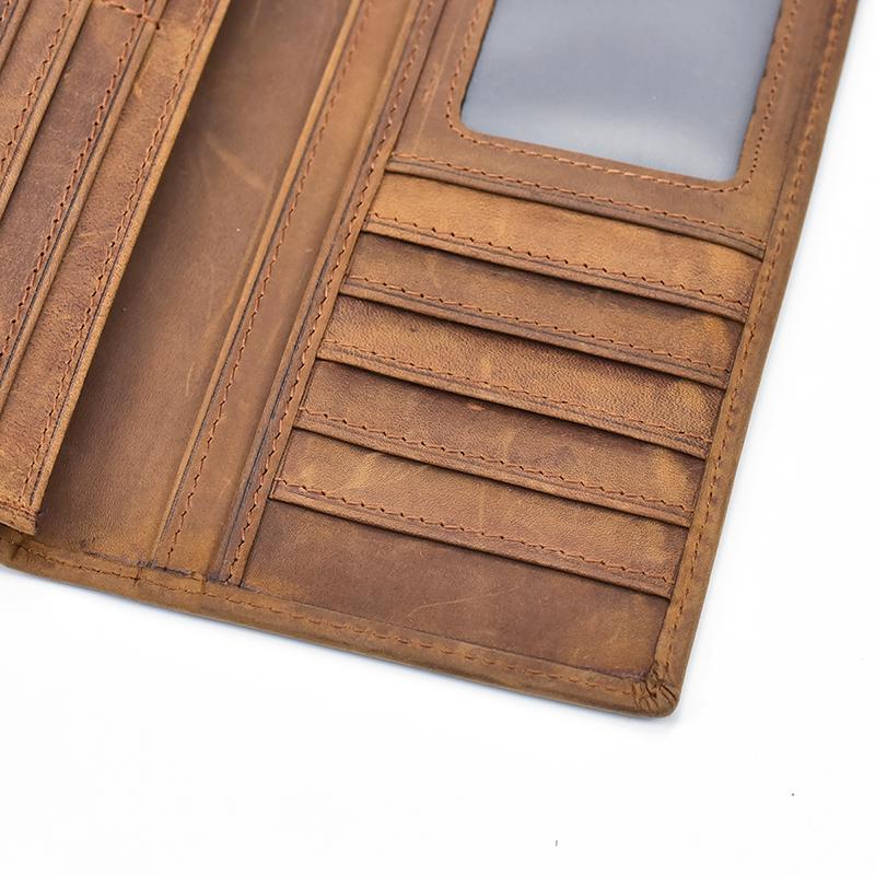 The Pathfinder Bifold Wallet made of genuine crazy horse leather, featuring multiple card holders, a large ID window, and a zippered pocket for coins.