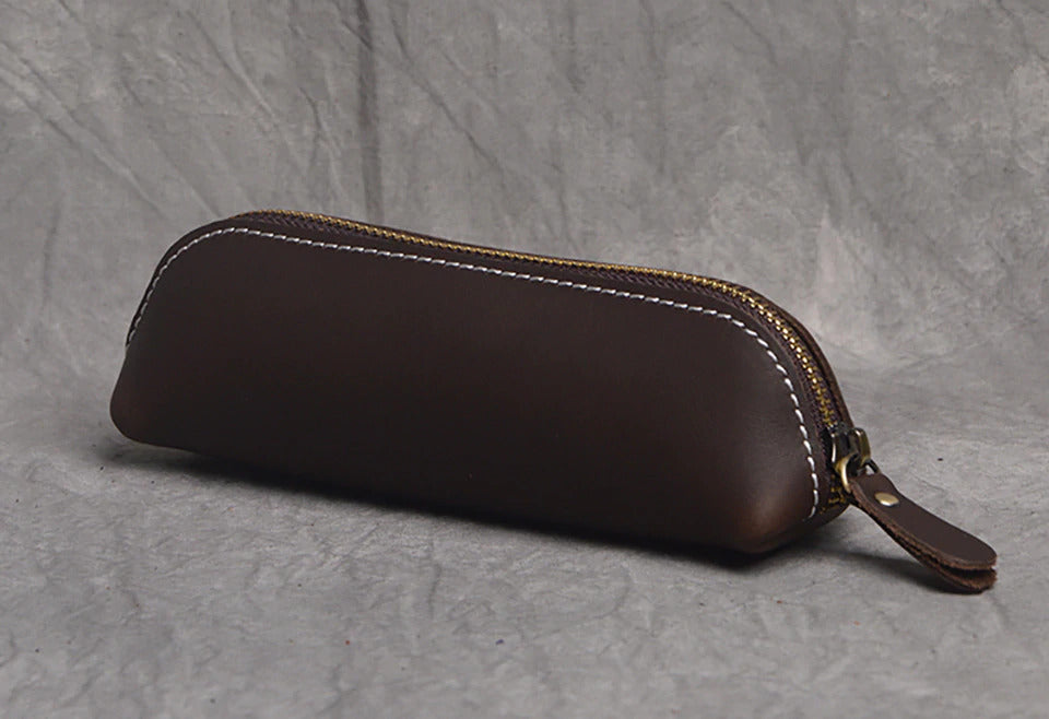 The Paavo Leather Pen Case made of full grain leather, featuring a brass YKK zipper, ideal for pens and makeup.