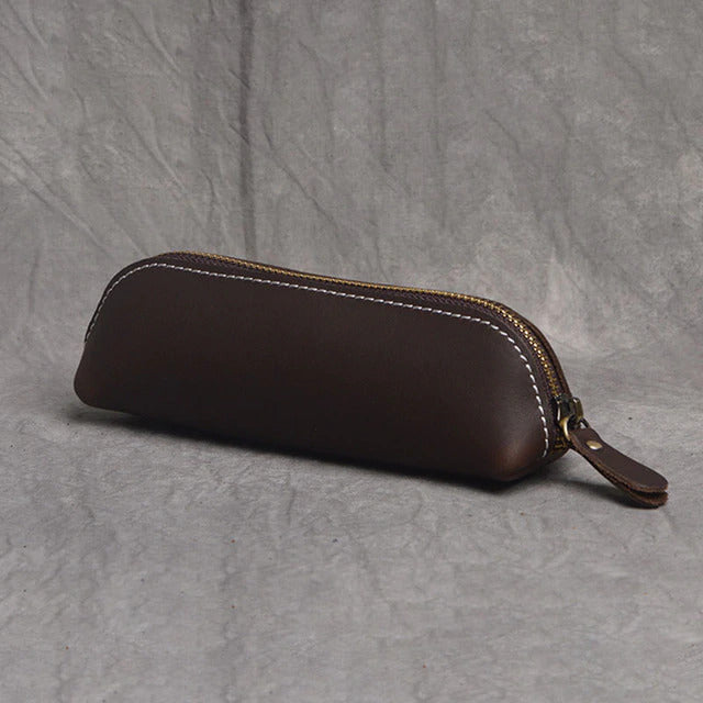 The Paavo Leather Pen Case made of full grain leather, featuring a brass YKK zipper, ideal for pens and makeup.