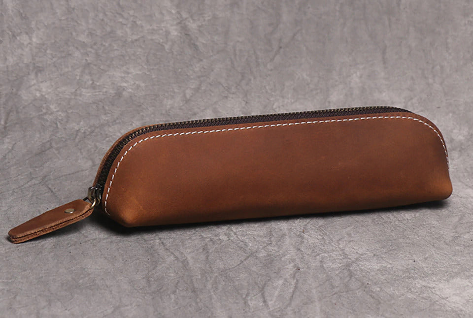 The Paavo Leather Pen Case made of full grain leather, featuring a brass YKK zipper, ideal for pens and makeup.