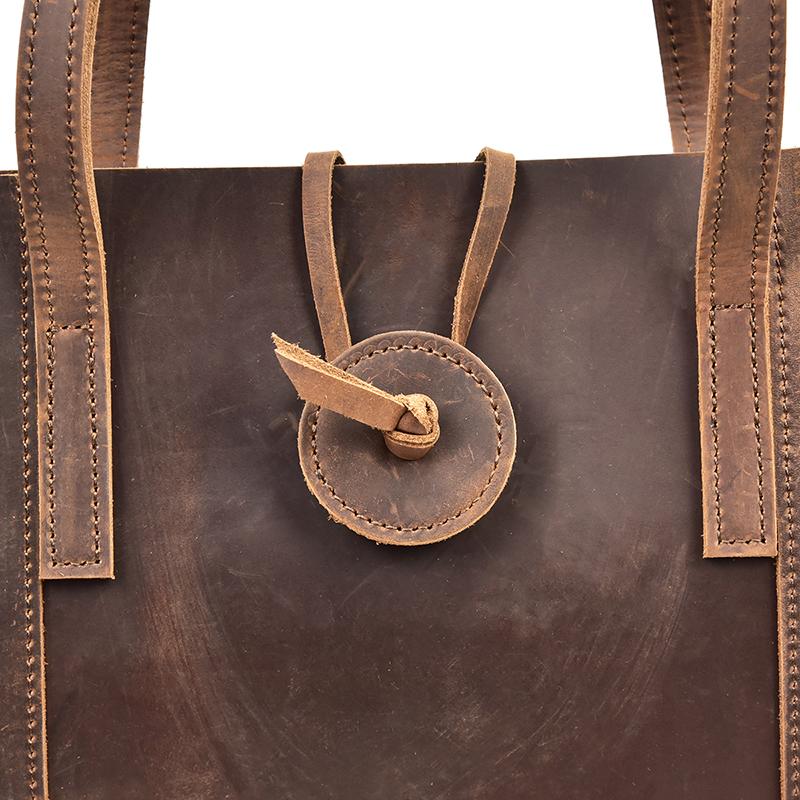 The Taavi Tote, a handcrafted leather tote bag, showcasing its unique crazy horse leather texture and spacious design.