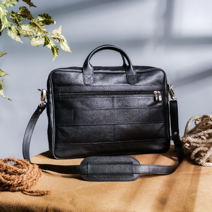 The Ultimate Leather Briefcase Bag in Black, showcasing premium top-grain cowhide leather with multiple compartments and an adjustable shoulder strap.