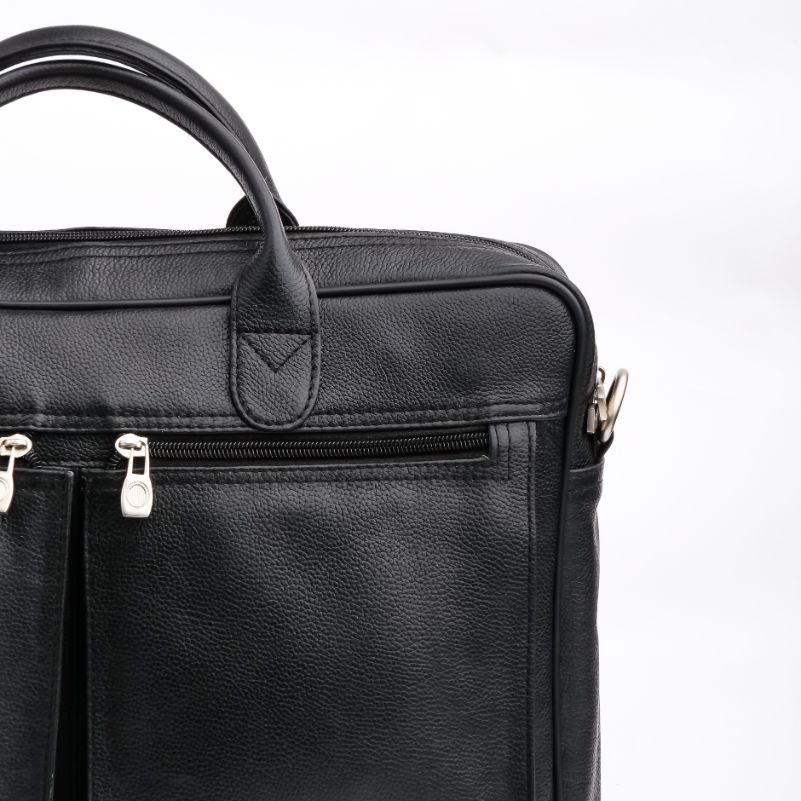 The Ultimate Leather Briefcase Bag in Black, showcasing premium top-grain cowhide leather with multiple compartments and an adjustable shoulder strap.