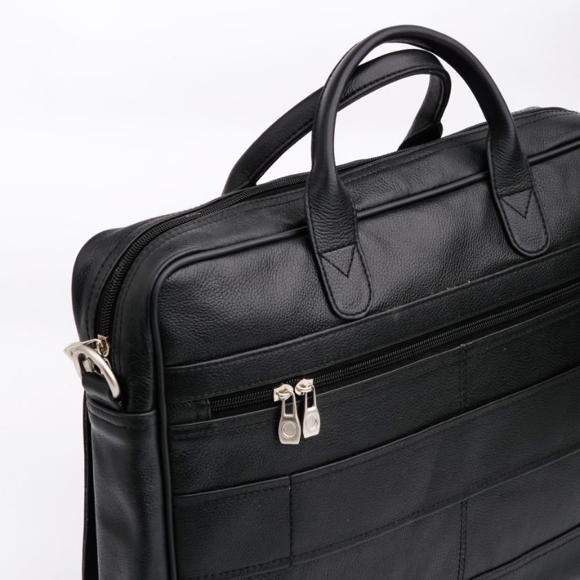 The Ultimate Leather Briefcase Bag in Black, showcasing premium top-grain cowhide leather with multiple compartments and an adjustable shoulder strap.