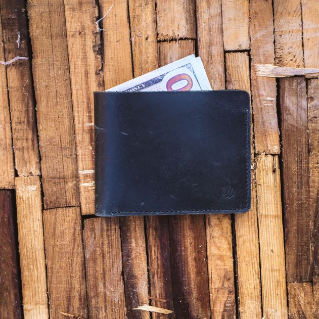 The Vault Vintage Leather Wallet in Charcoal Black, showcasing its unique vintage wash effect and hand-pressed aged edges.