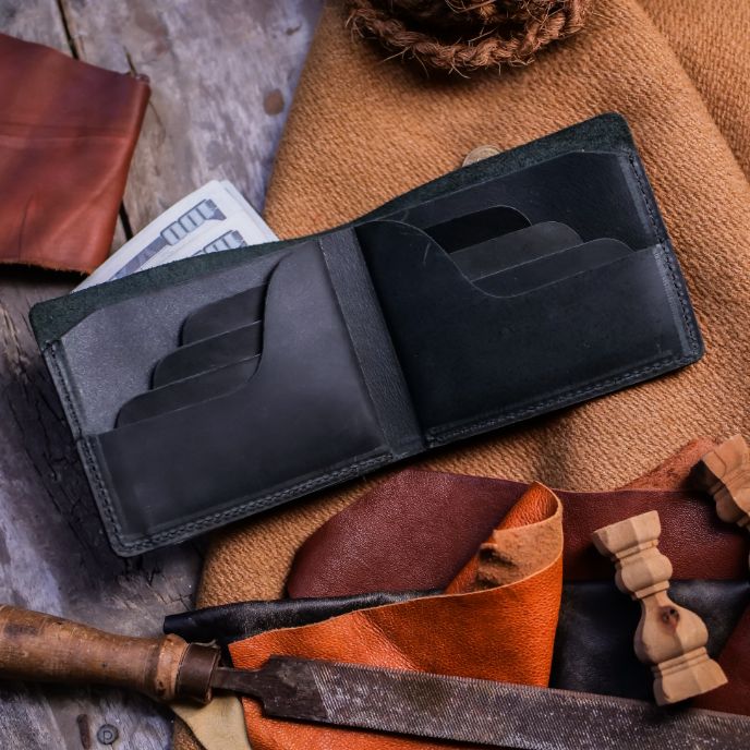 The Vault Vintage Leather Wallet in Charcoal Black, showcasing its unique vintage wash effect and hand-pressed aged edges.