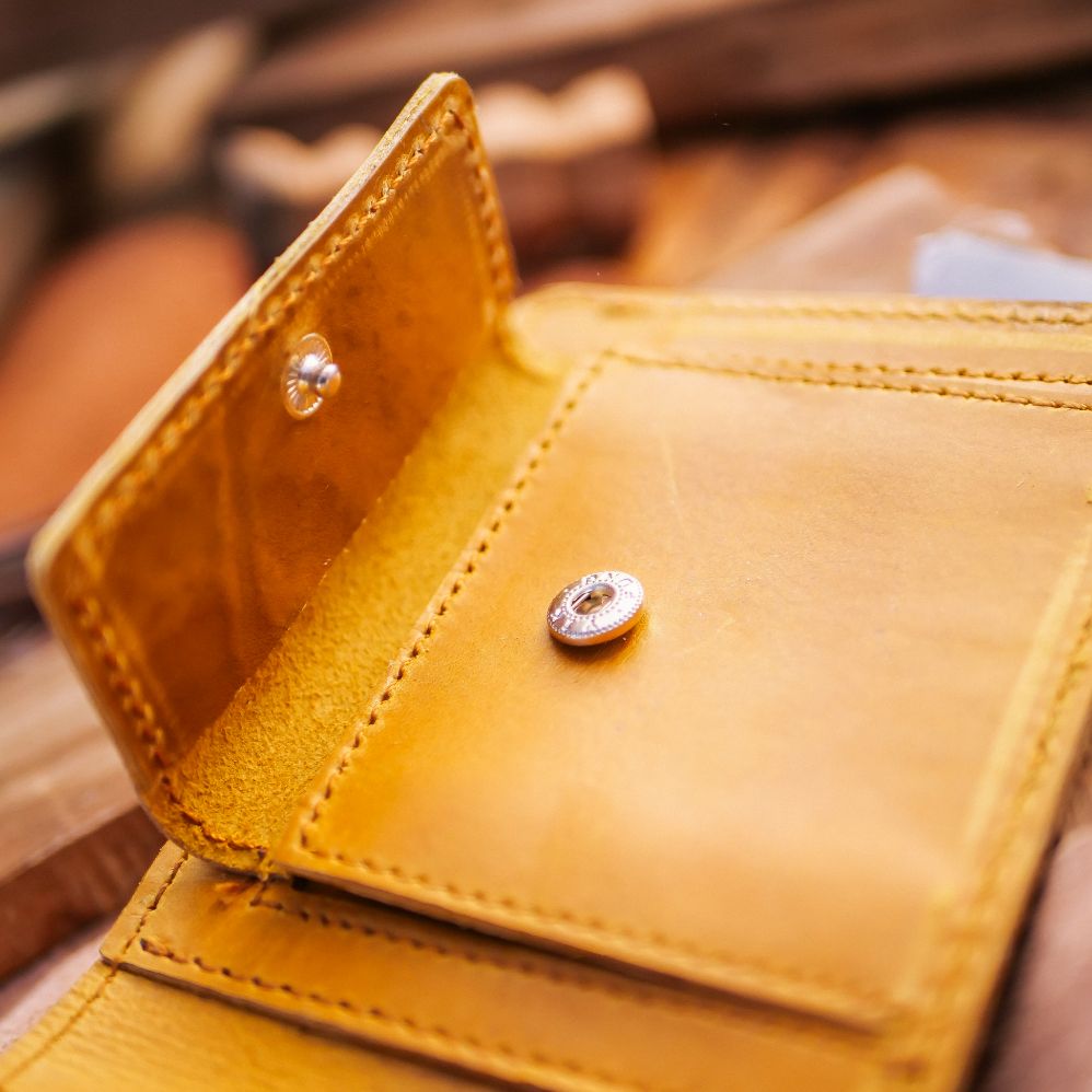 The Vault Vintage Leather Wallet in Wood Brown, showcasing its unique vintage wash effect and hand-pressed aged edges.