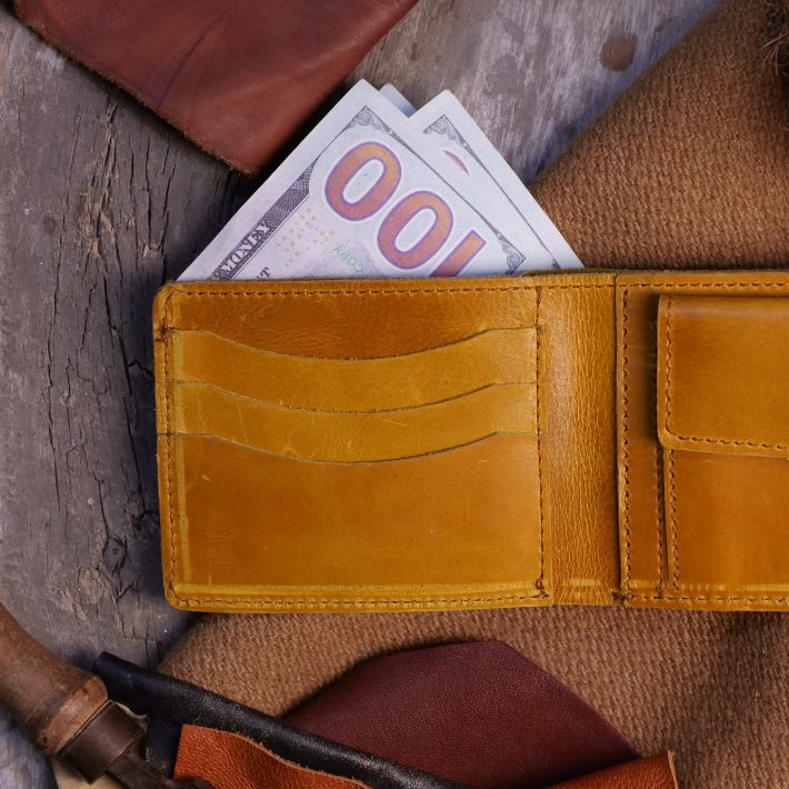 The Vault Vintage Leather Wallet in Wood Brown, showcasing its unique vintage wash effect and hand-pressed aged edges.