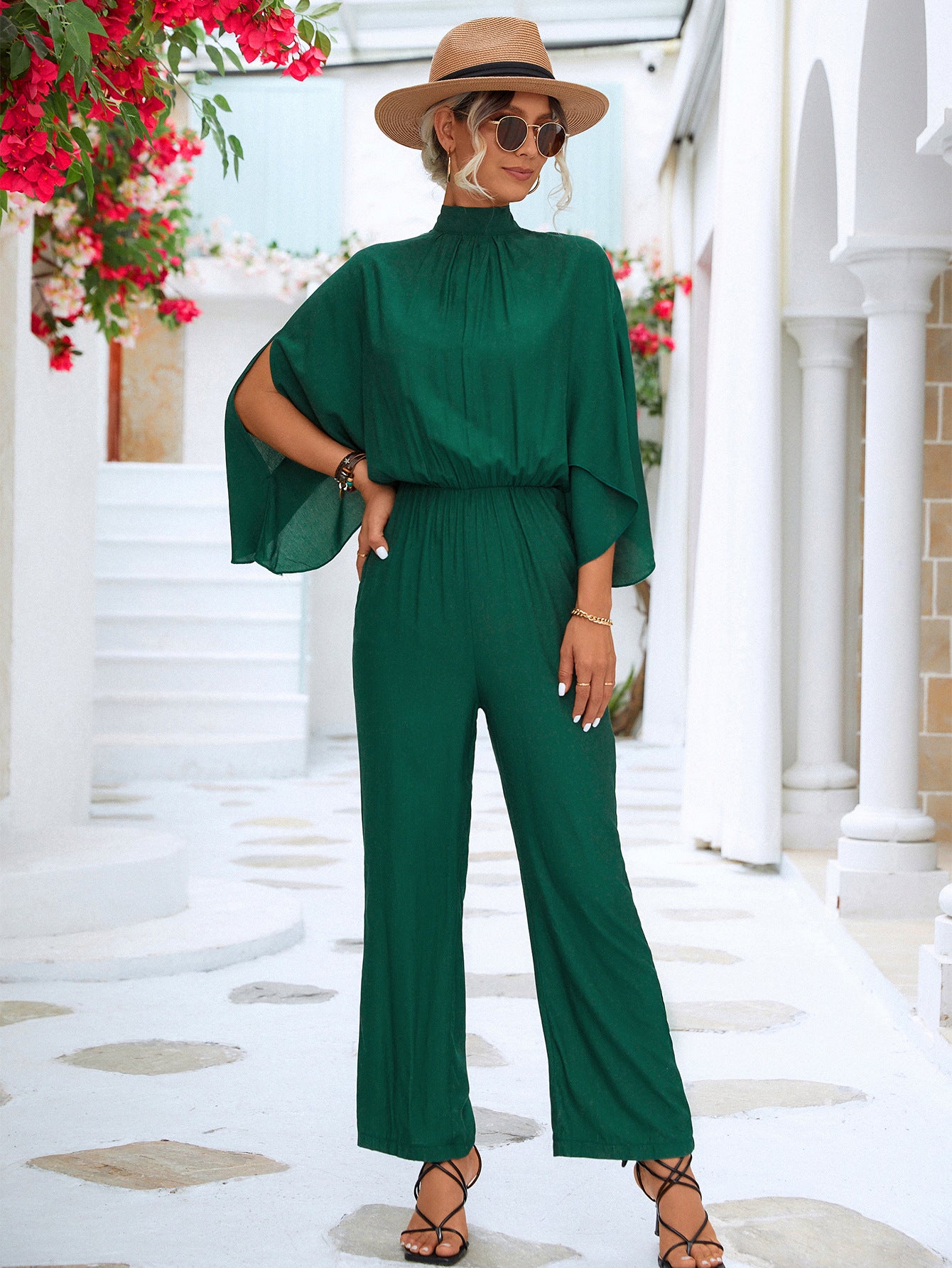 A stylish Tie Back Mock Neck Split Sleeve Jumpsuit displayed on a mannequin, featuring a mock neck and split sleeves in a solid color.