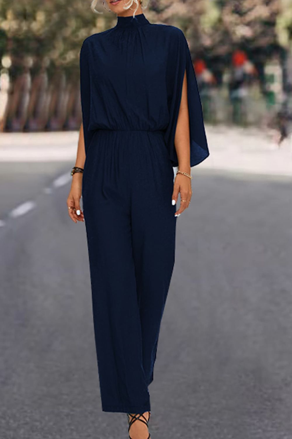 A stylish Tie Back Mock Neck Split Sleeve Jumpsuit displayed on a mannequin, featuring a mock neck and split sleeves in a solid color.