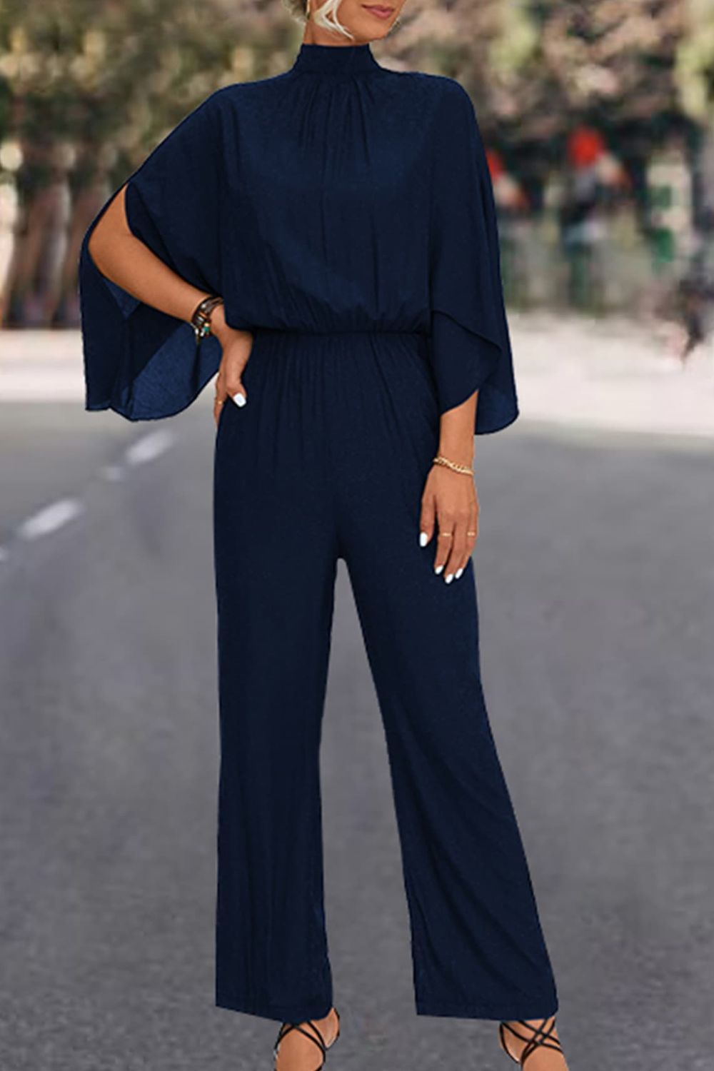 A stylish Tie Back Mock Neck Split Sleeve Jumpsuit displayed on a mannequin, featuring a mock neck and split sleeves in a solid color.