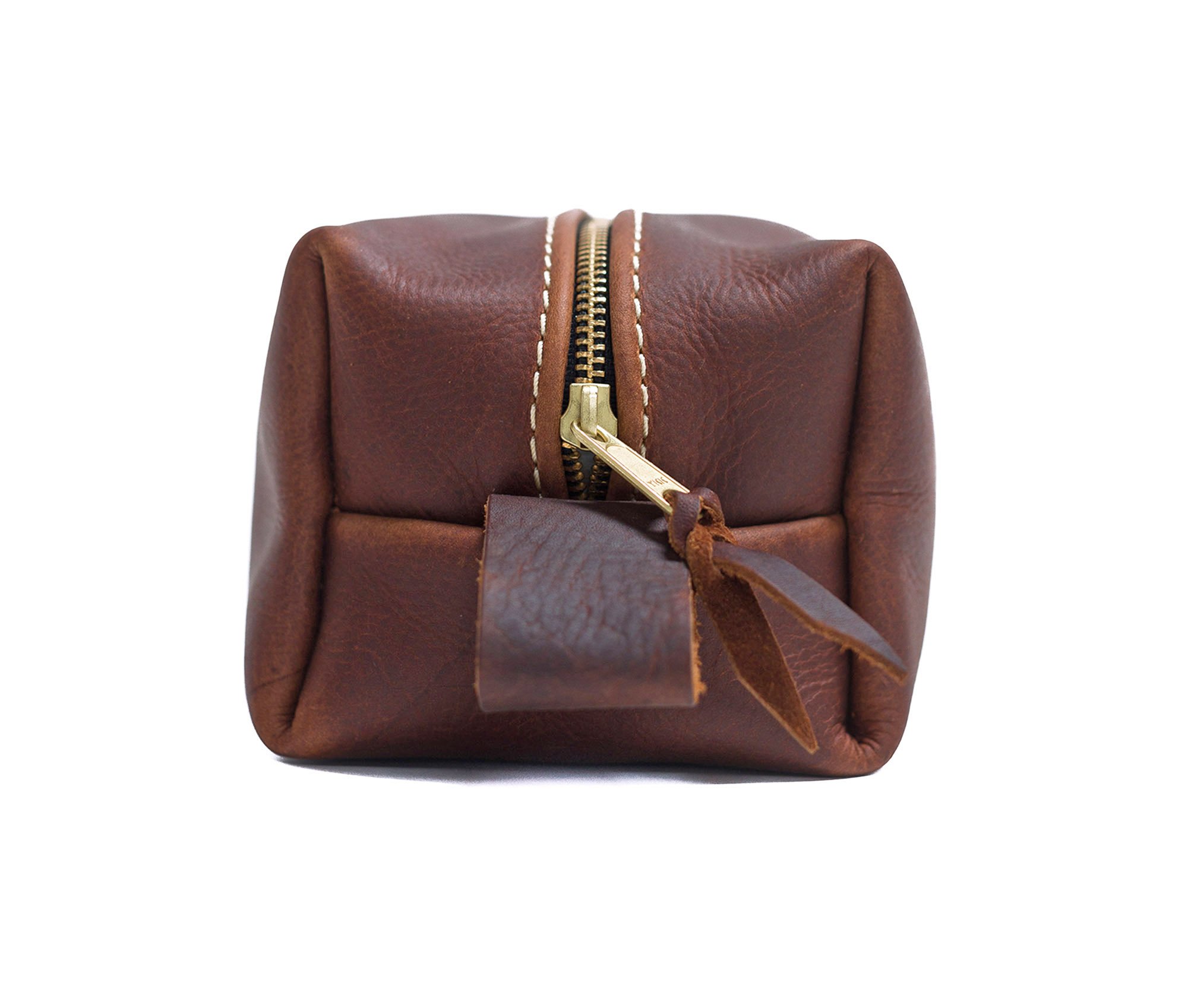 Handcrafted full grain leather toiletry bag with heavy duty zipper and water-resistant liner, perfect for travel.