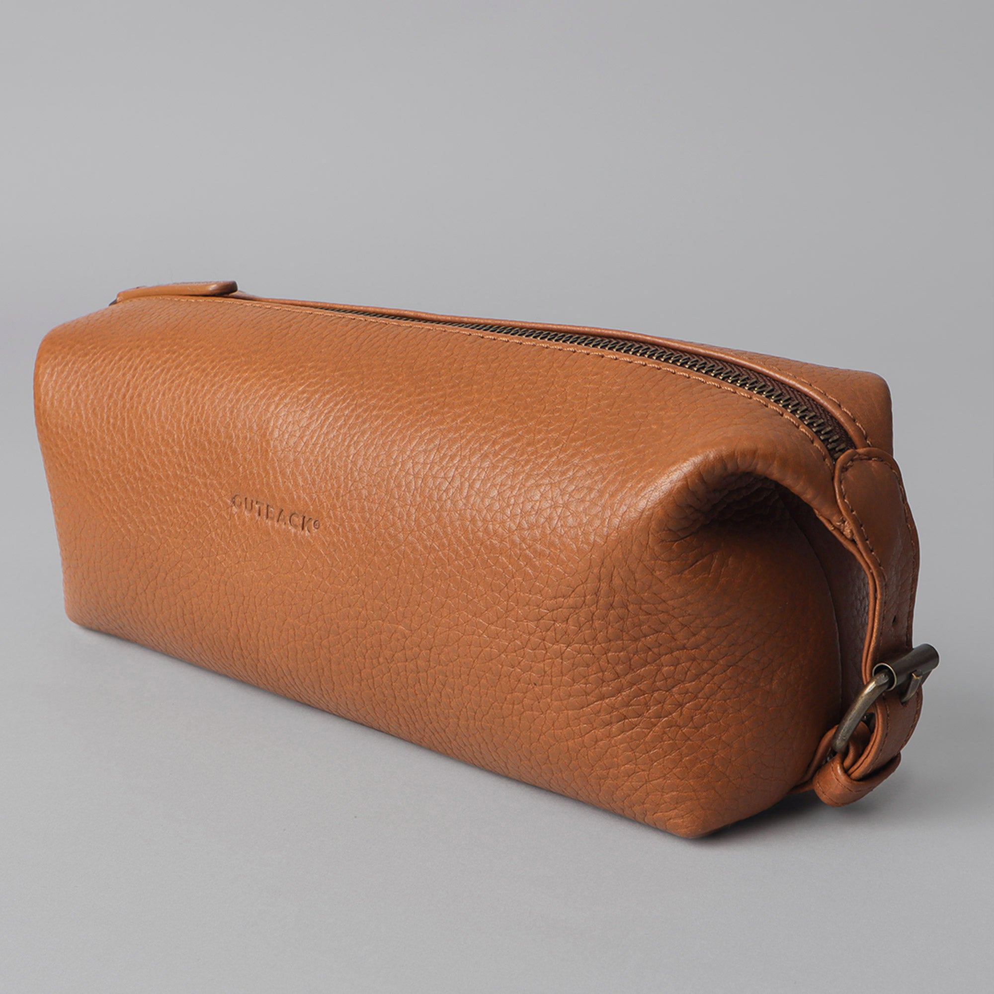 Tokyo Toilet Bag made of premium full grain leather, featuring a spacious interior, zipper pocket, and antique brass hardware.