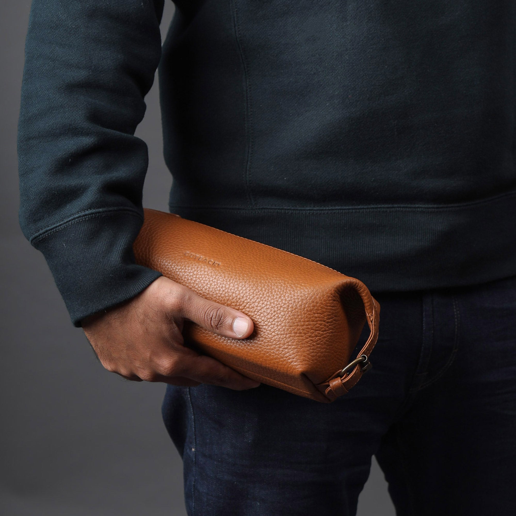 Tokyo Toilet Bag made of premium full grain leather, featuring a spacious interior, zipper pocket, and antique brass hardware.