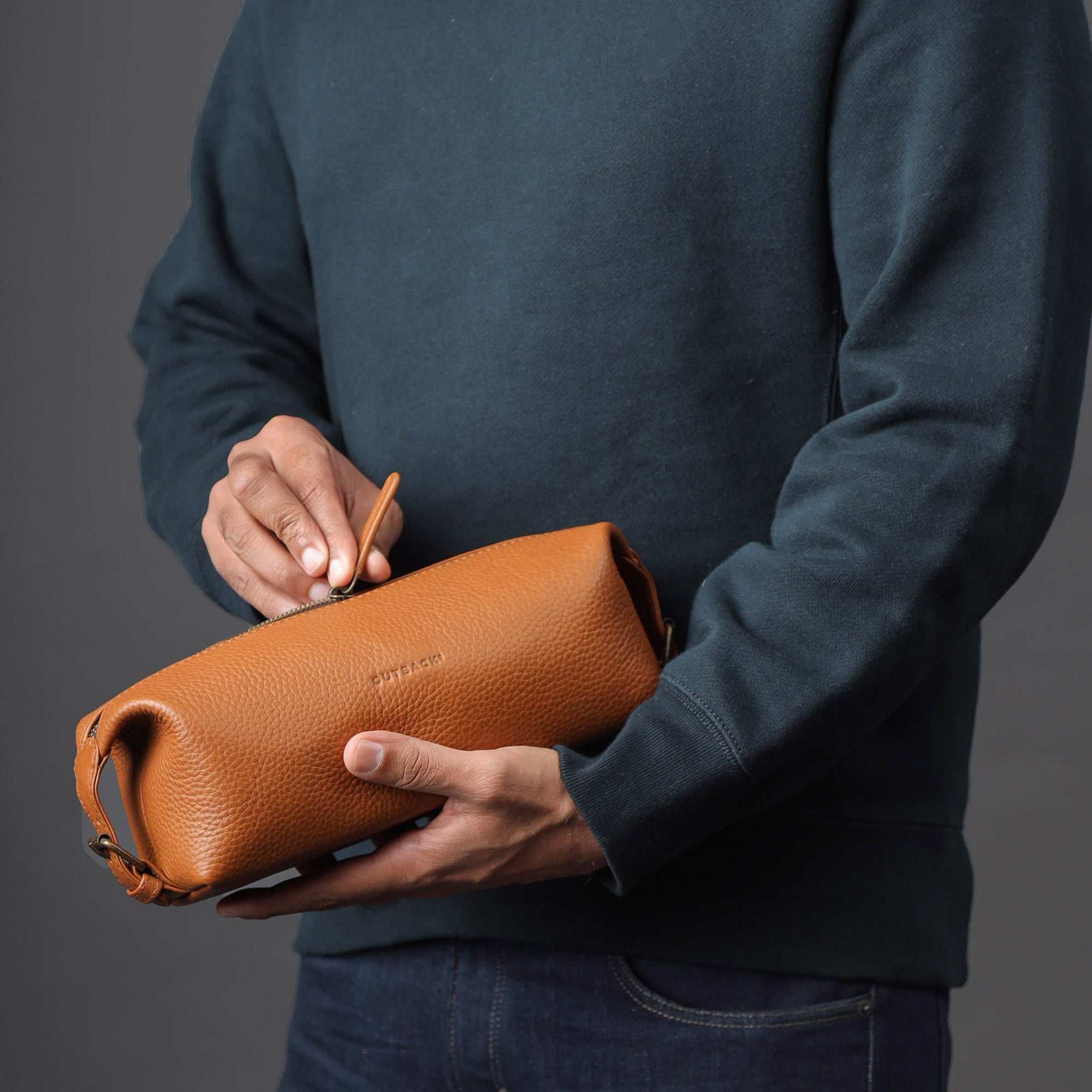 Tokyo Toilet Bag made of premium full grain leather, featuring a spacious interior, zipper pocket, and antique brass hardware.