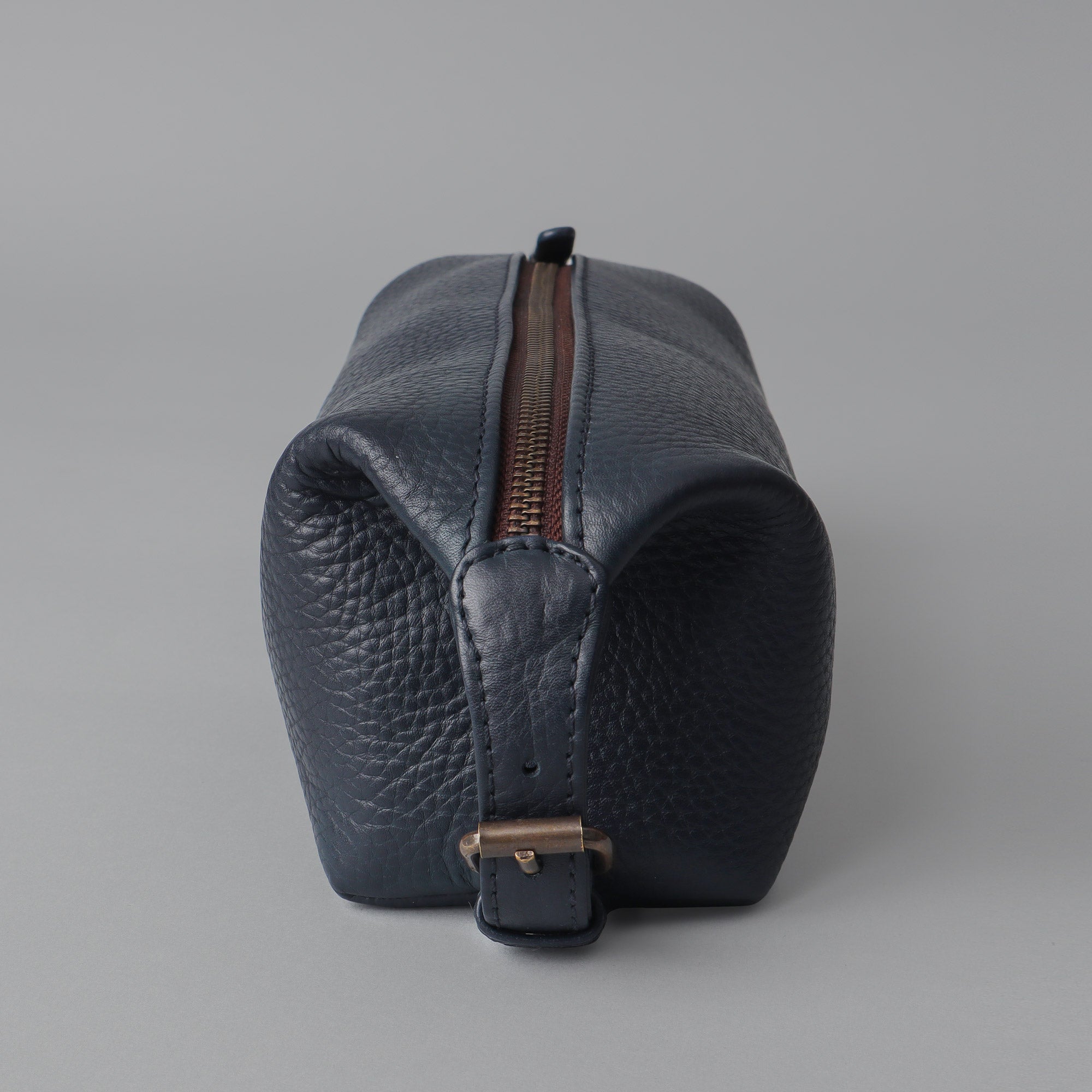 Tokyo Toilet Bag made from premium full grain leather, featuring a spacious design and brass hardware.