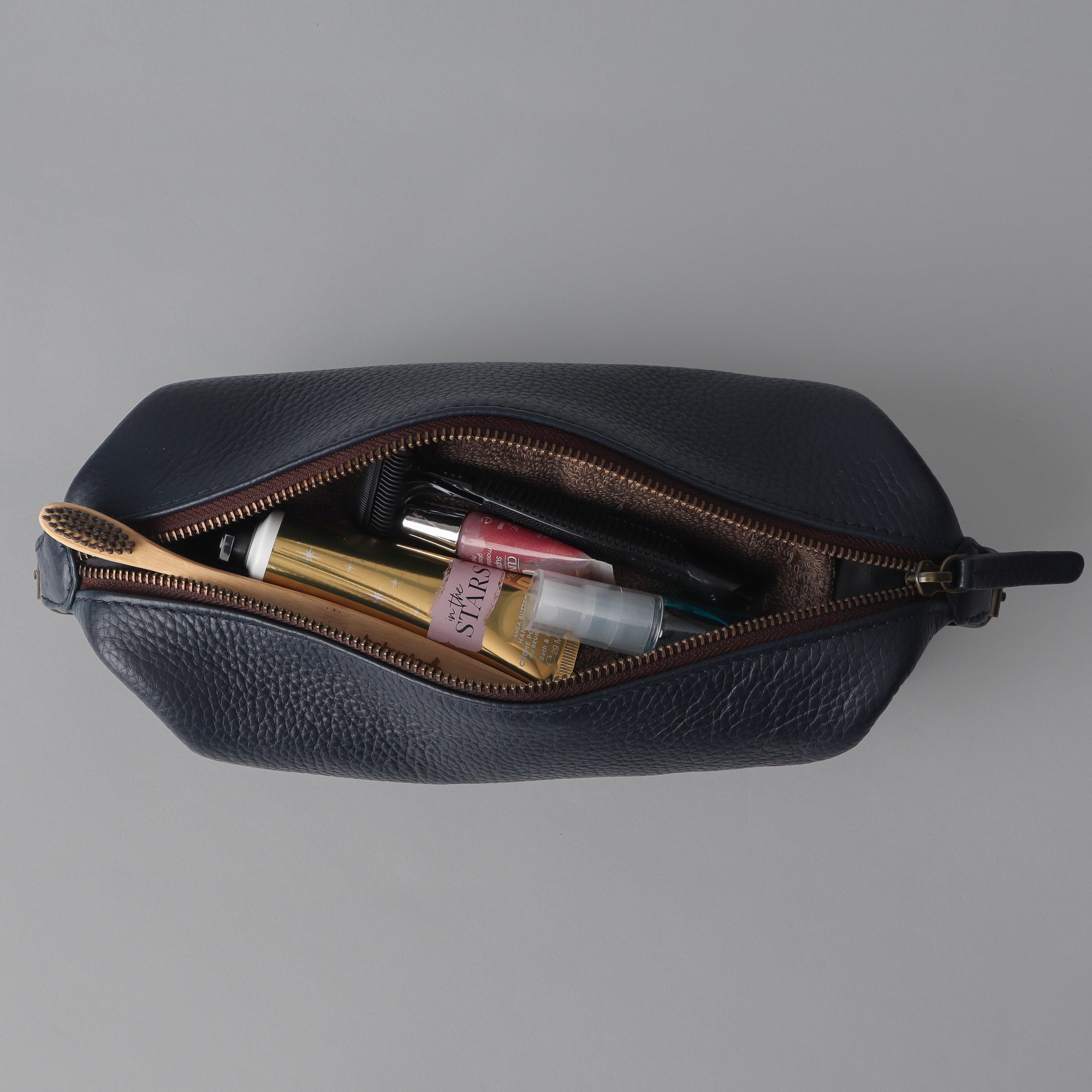 Tokyo Toilet Bag made from premium full grain leather, featuring a spacious design and brass hardware.