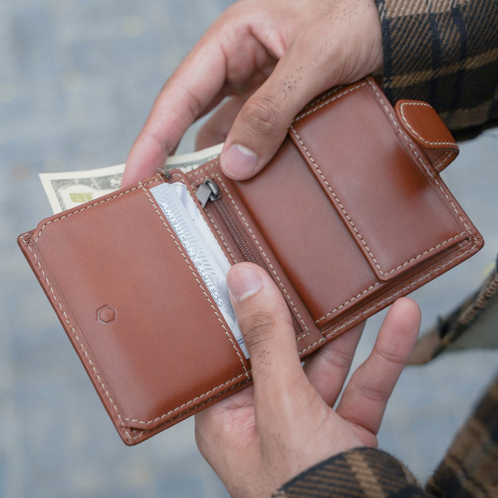 Tri Fold Wallet in Clay color with zipped coin pouch, showcasing its compact design and stylish appearance.