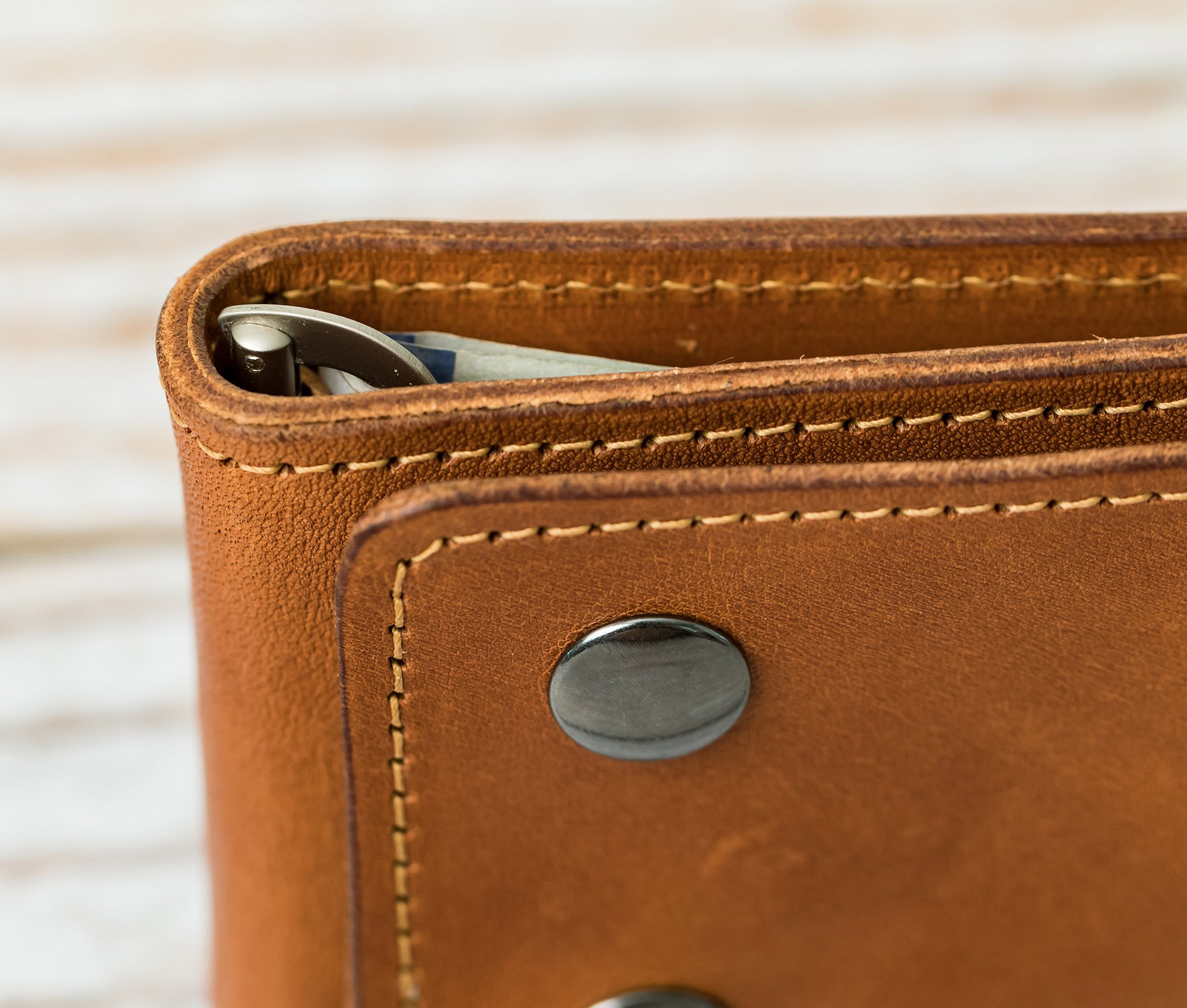 A stylish Trifold Wallet made of authentic full grain leather, featuring a center money clip and personalized initials.