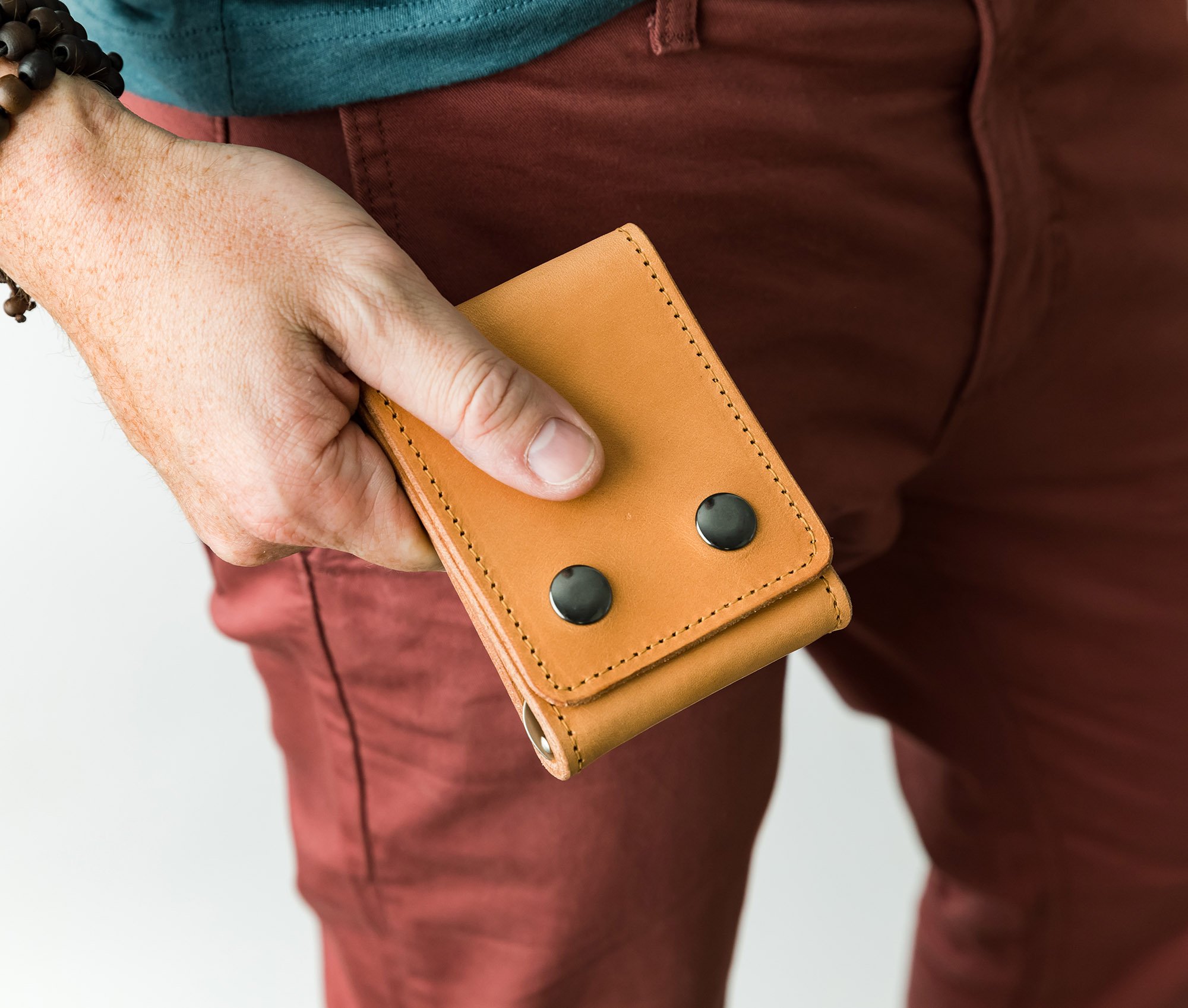 A stylish Trifold Wallet made of authentic full grain leather, featuring a center money clip and personalized initials.