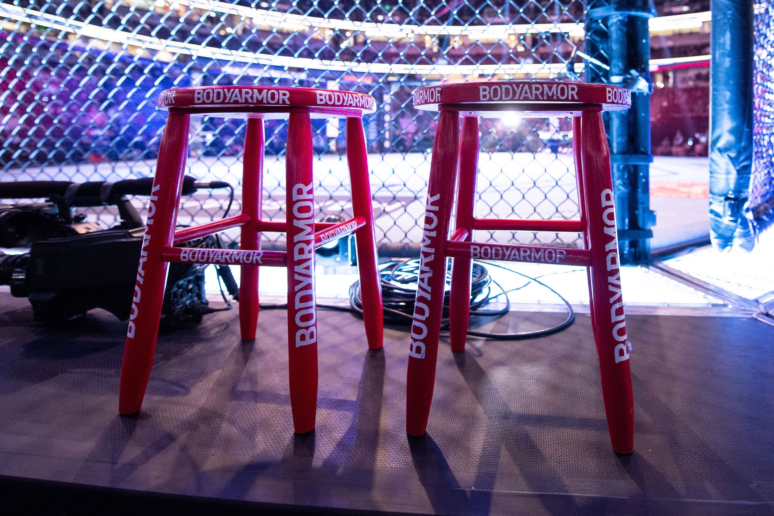 Red UFC corner stool used in the Octagon during UFC 282: Błachowicz vs. Ankalaev, showcasing wear from the event.