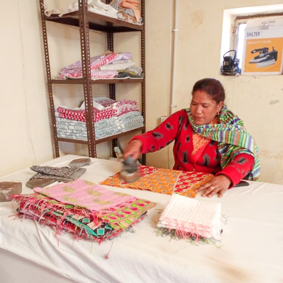 A vibrant upcycled sari cotton kantha infinity scarf showcasing unique patterns and colors, hand-stitched with traditional kantha technique.