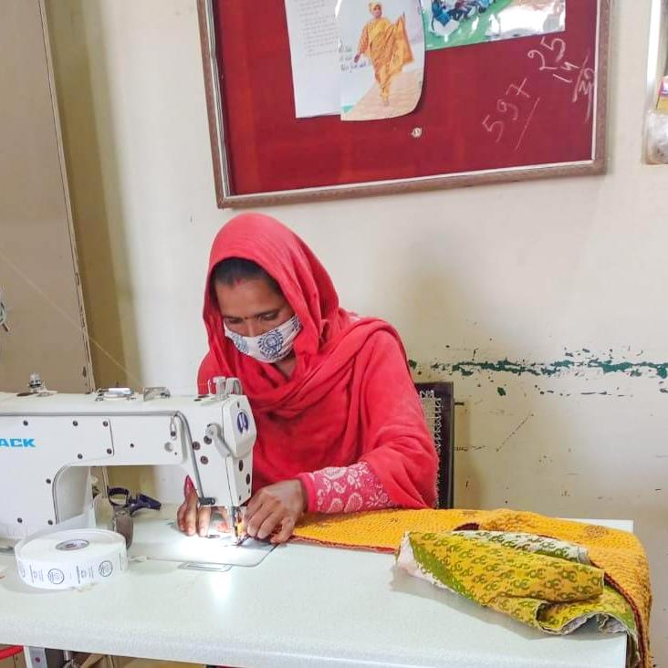 A vibrant upcycled sari cotton kantha infinity scarf showcasing unique patterns and colors, hand-stitched with traditional kantha technique.