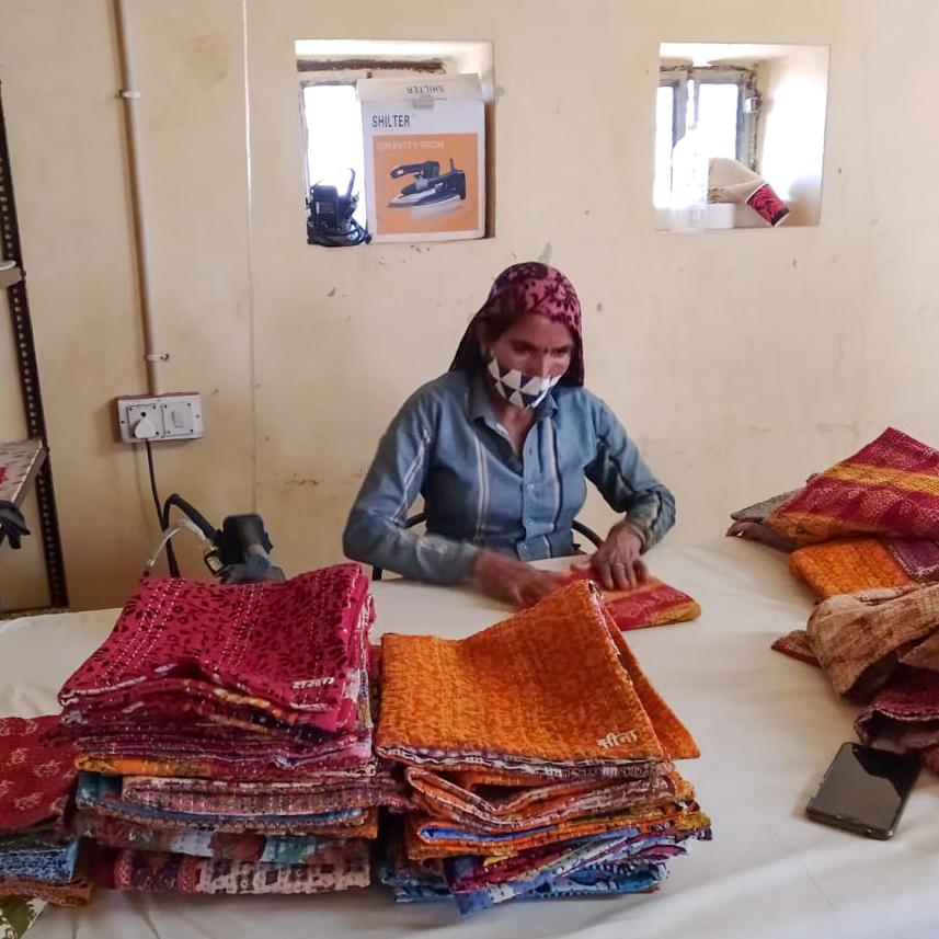 A vibrant upcycled sari cotton kantha infinity scarf showcasing unique patterns and colors, hand-stitched with traditional kantha technique.