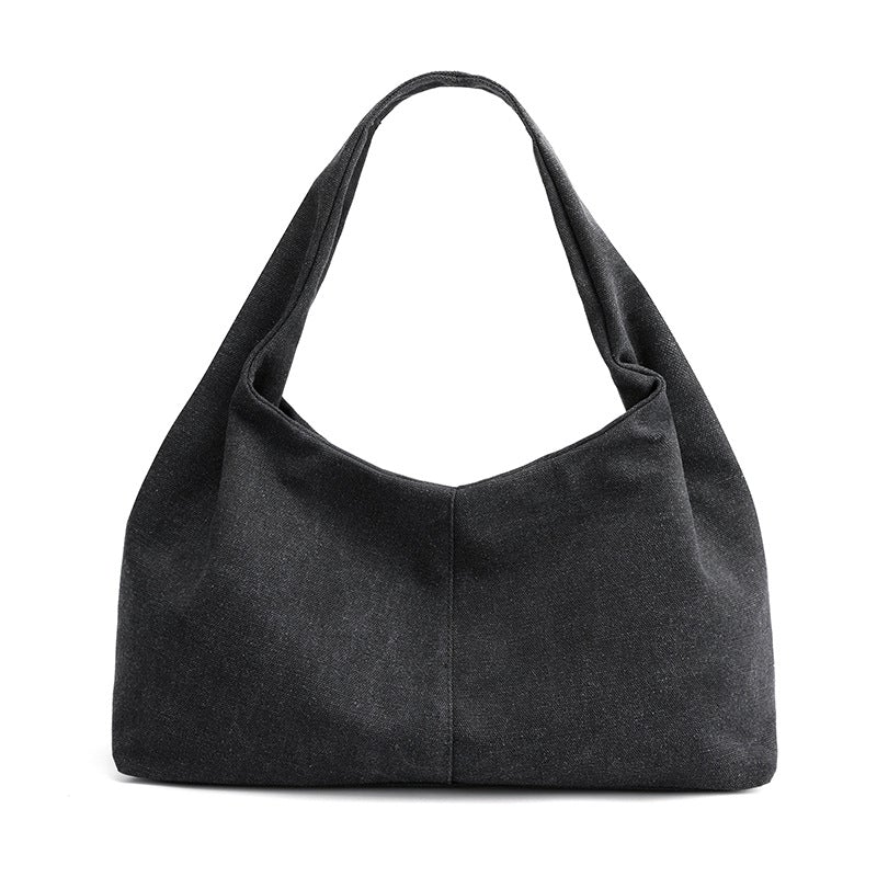 Urban Simplicity Japanese Style Canvas Handbag in a chic dumpling shape, made from durable canvas with a zipper opening.