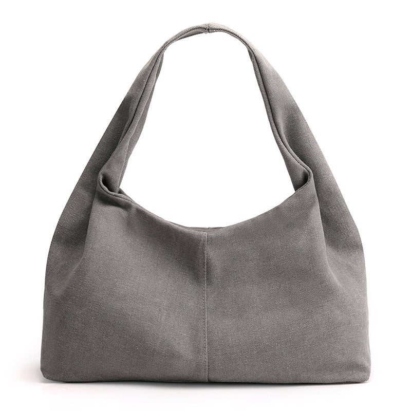 Urban Simplicity Japanese Style Canvas Handbag in a chic dumpling shape, made from durable canvas with a zipper opening.