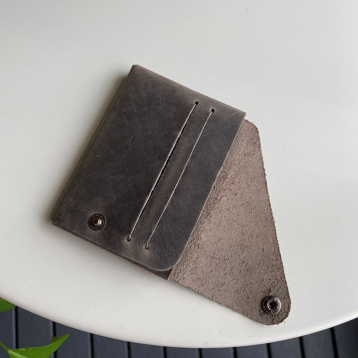 Vista Genuine Leather Folding Wallet in various colors, showcasing its thin, stitchless design and minimalistic style.