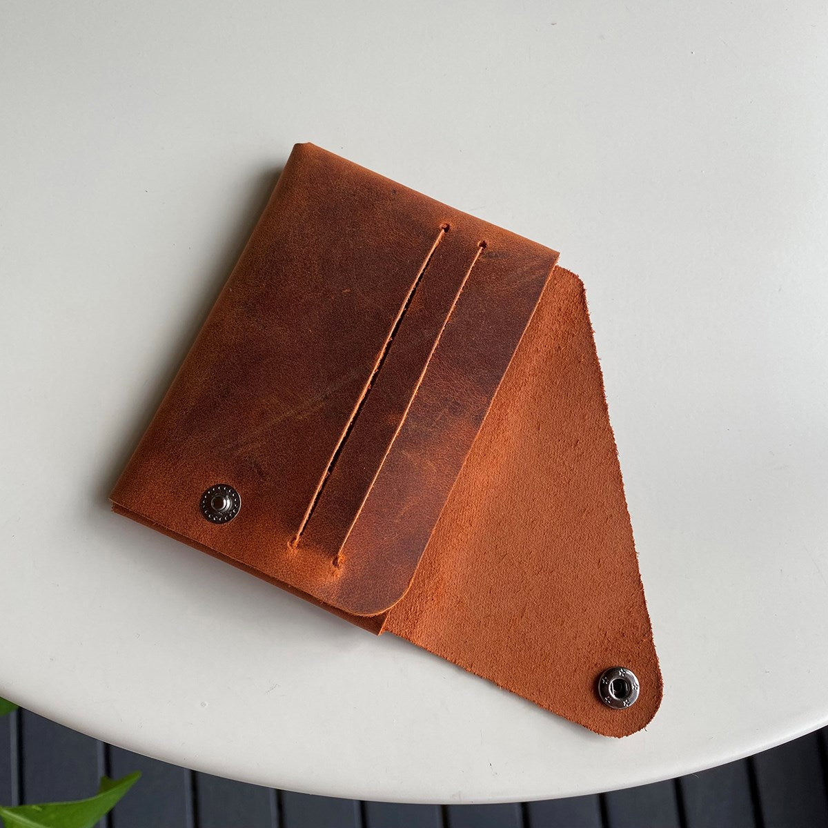 Vista Genuine Leather Folding Wallet in various colors, showcasing its thin, stitchless design and minimalistic style.