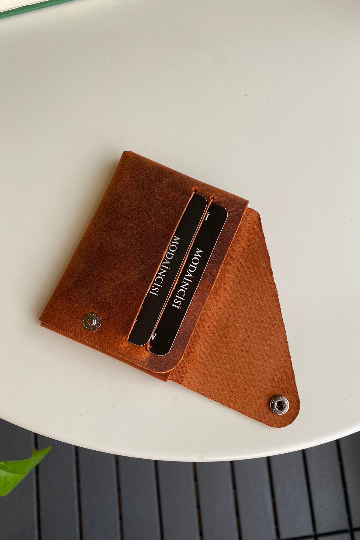 Vista Genuine Leather Folding Wallet in various colors, showcasing its thin, stitchless design and minimalistic style.