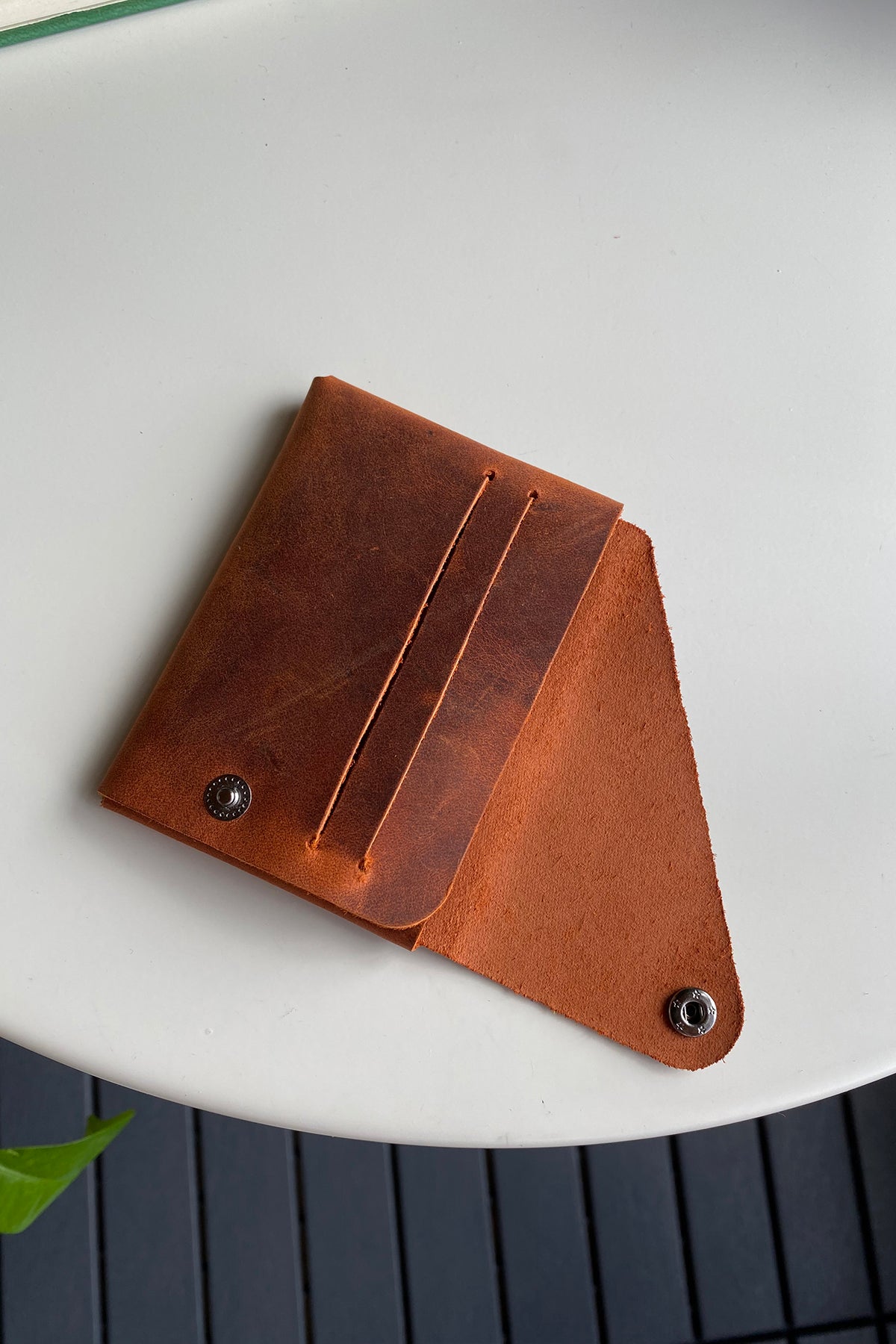 Vista Genuine Leather Folding Wallet in various colors, showcasing its thin, stitchless design and minimalistic style.