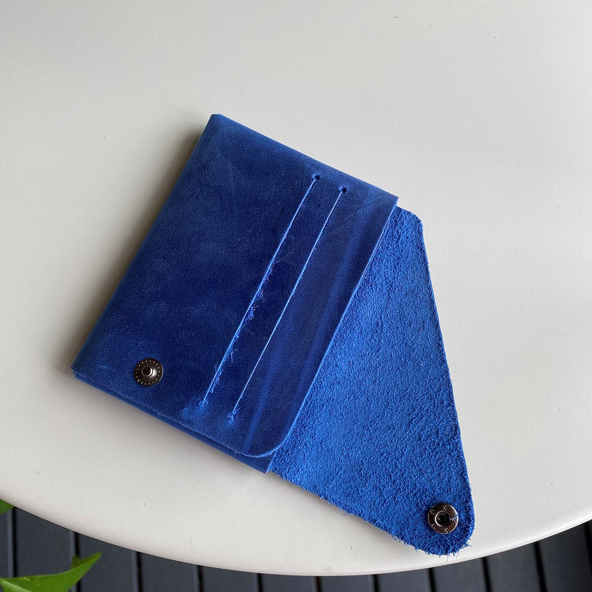 Vista Genuine Leather Folding Wallet in various colors, showcasing its thin, stitchless design and minimalistic style.