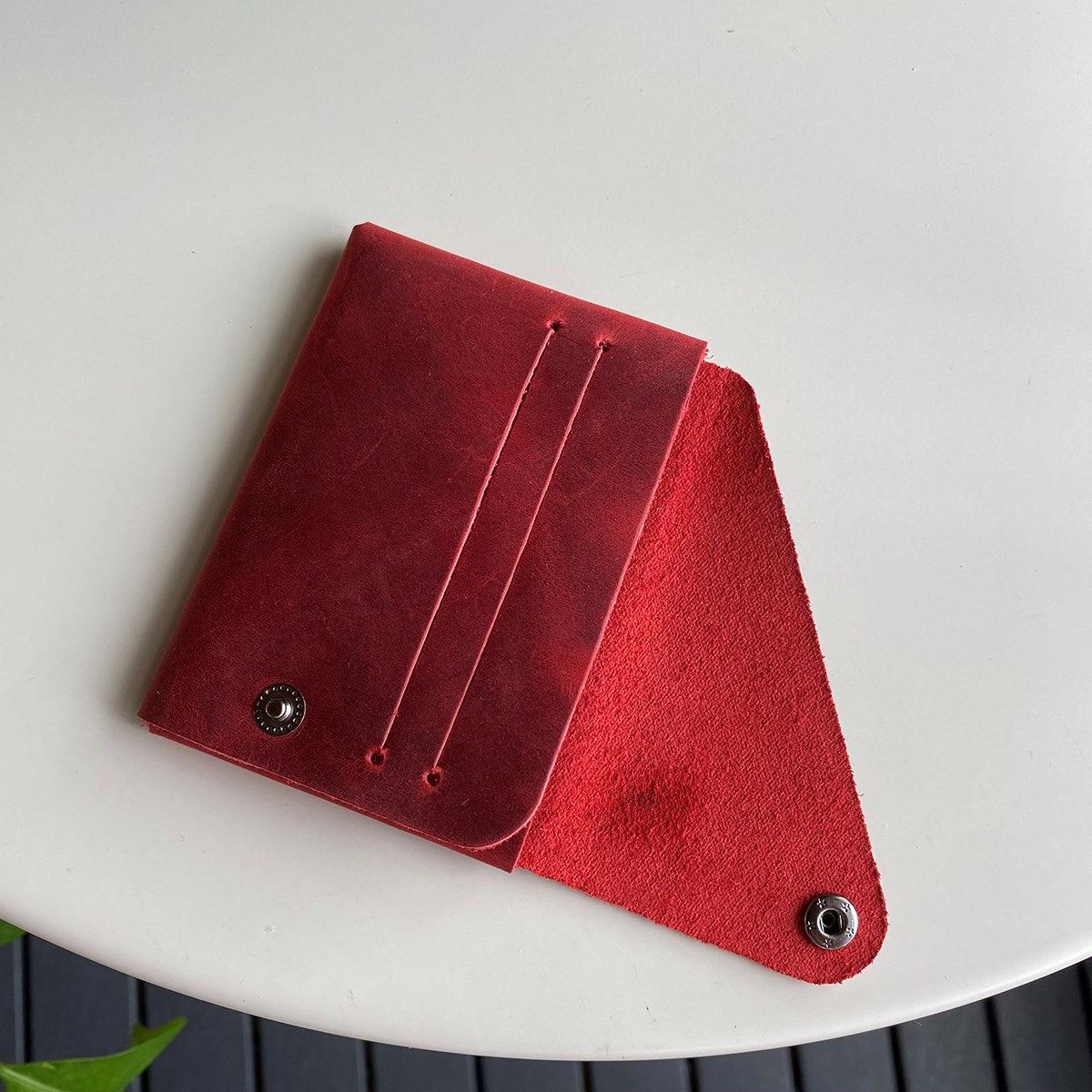 Vista Genuine Leather Folding Wallet in various colors, showcasing its thin, stitchless design and minimalistic style.