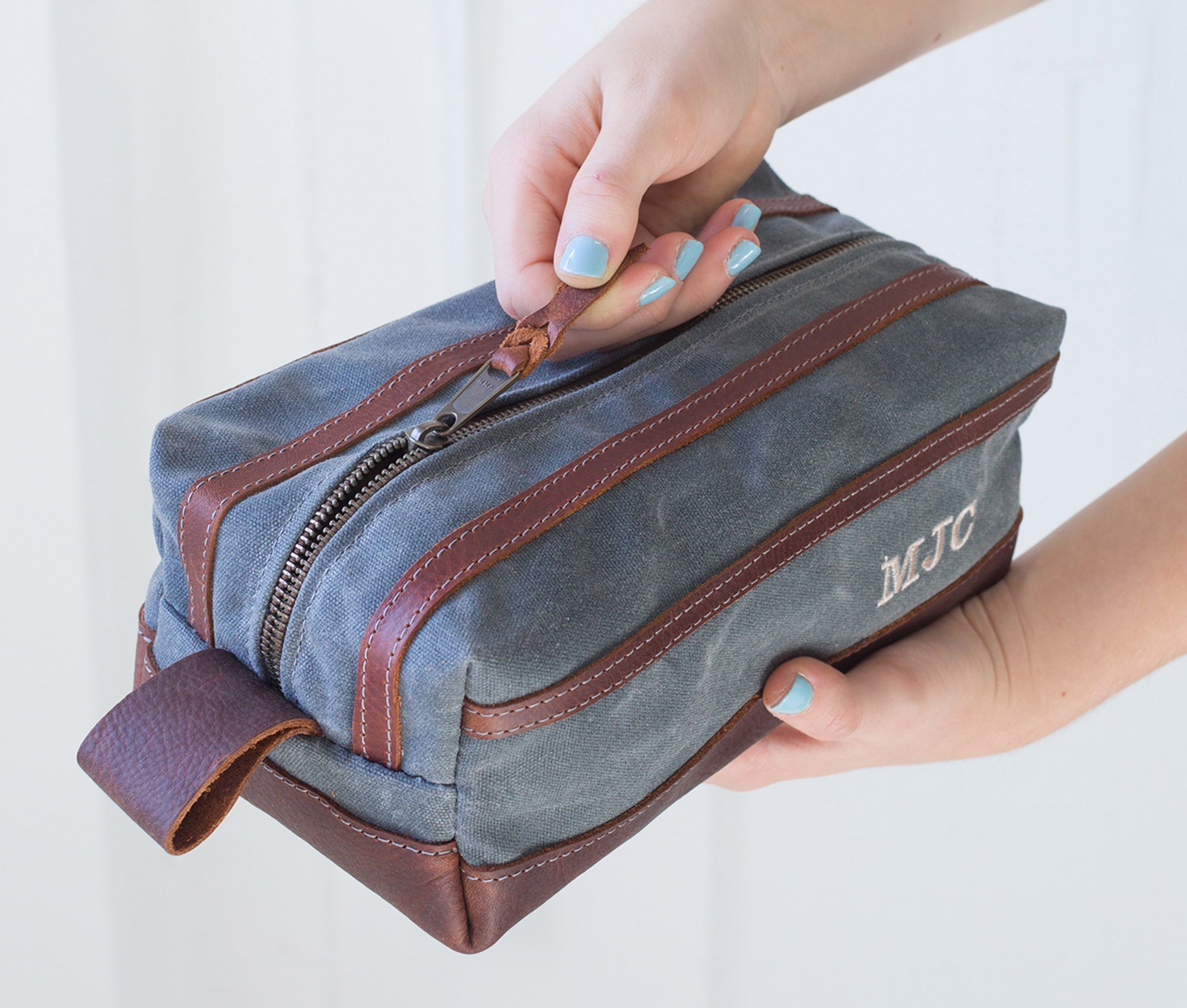 Waxed Canvas Toiletry Bag featuring leather accents, water-resistant liner, and heavy-duty zipper, ideal for travel and everyday use.