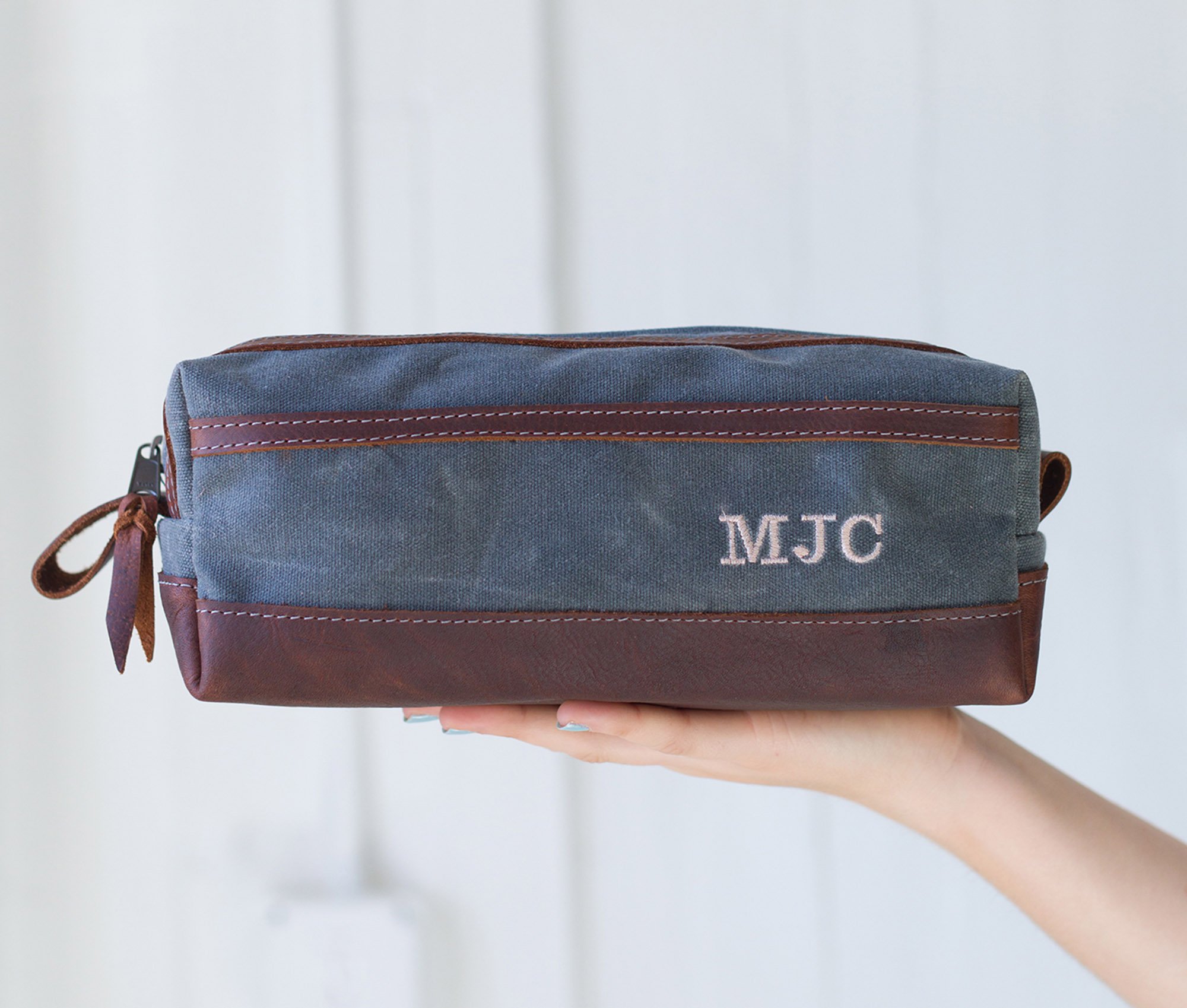 Waxed Canvas Toiletry Bag featuring leather accents, water-resistant liner, and heavy-duty zipper, ideal for travel and everyday use.