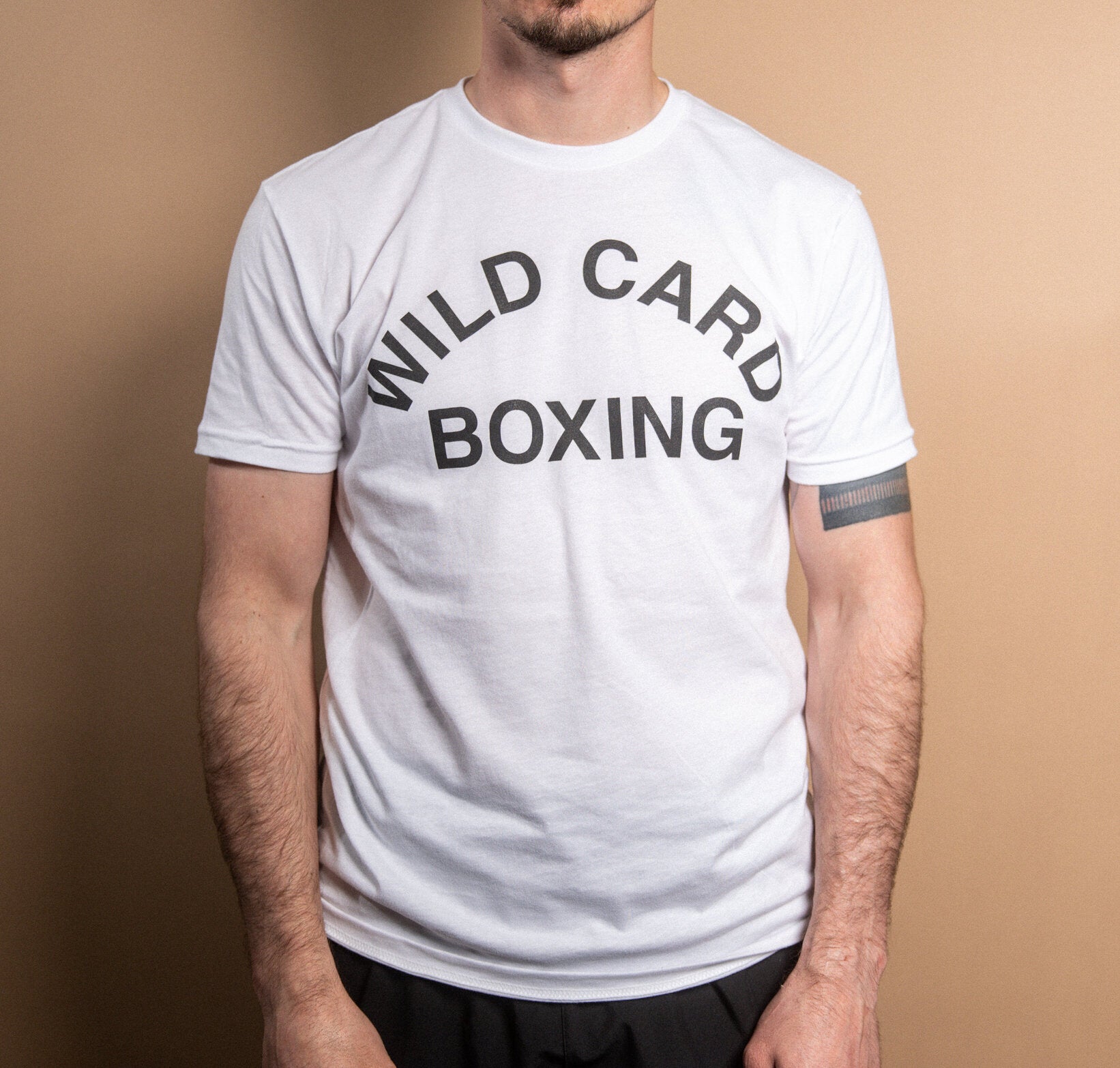 WCB Old School Logo T-Shirt in white and black, featuring classic Wild Card Boxing design, soft triblend material, and athletic fit.